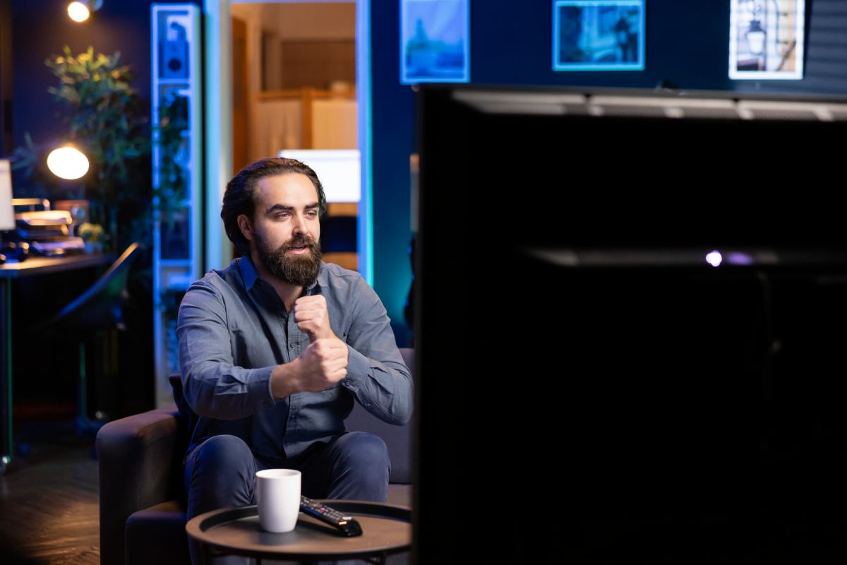 person streaming content fascinated by entertaining movie scene - IPTV Dark